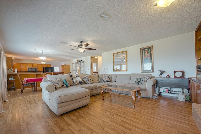 220 Hillcrest Dr, Coldspring, TX 77331 - living room with light wood-style floors, a textured ceiling, and ceiling fan
