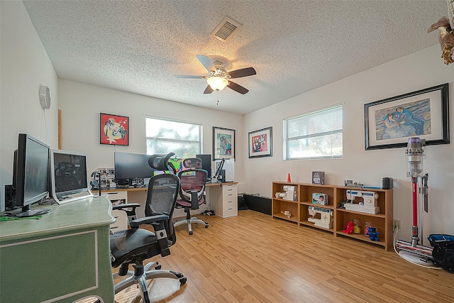 220 Hillcrest Dr, Coldspring, TX 77331 - office space featuring plenty of natural light, light wood-style flooring, ceiling fan, and a textured ceiling