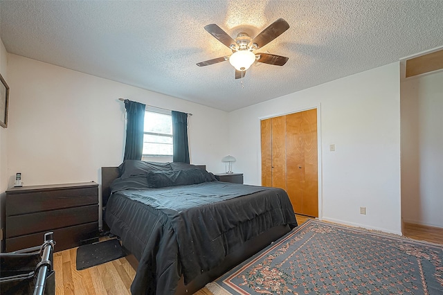 220 Hillcrest Dr, Coldspring, TX 77331 - bedroom with light wood-type flooring, a textured ceiling, ceiling fan, and a closet