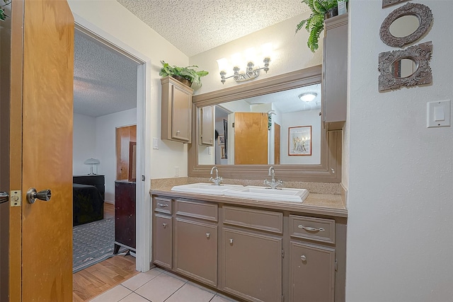 220 Hillcrest Dr, Coldspring, TX 77331 - full bathroom with a textured ceiling, ensuite bathroom, double vanity, and tile patterned floors