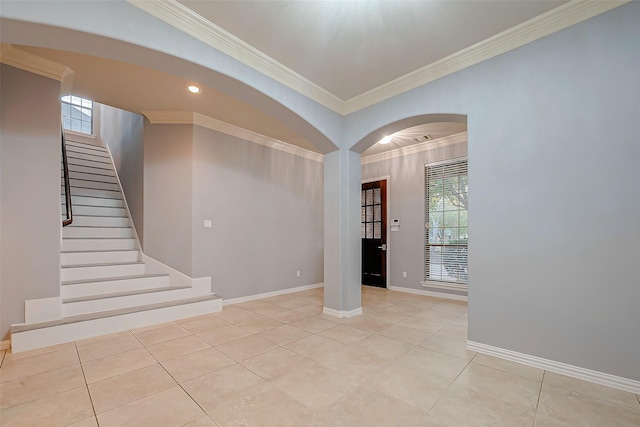 18306 S Austin Shore Dr, Cypress, TX 77433 - empty room featuring ornamental molding, stairway, light tile patterned floors, baseboards, and arched walkways