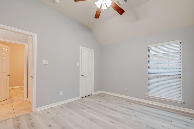 18306 S Austin Shore Dr, Cypress, TX 77433 - unfurnished bedroom with light wood-type flooring, vaulted ceiling, baseboards, and a ceiling fan