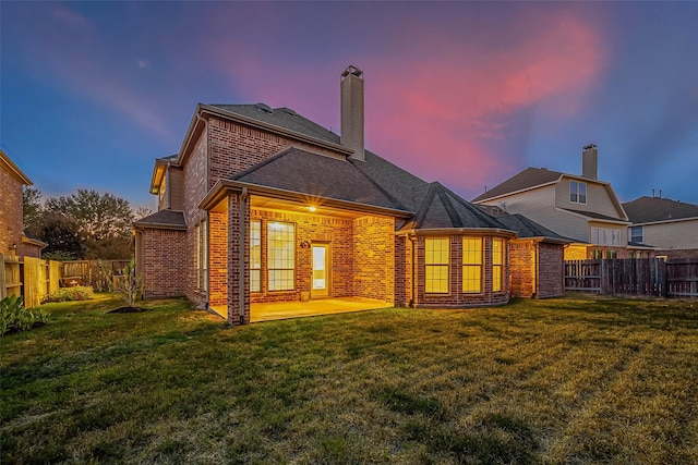 18306 S Austin Shore Dr, Cypress, TX 77433 - rear view of property featuring brick siding, a chimney, a patio area, and a shingled roof