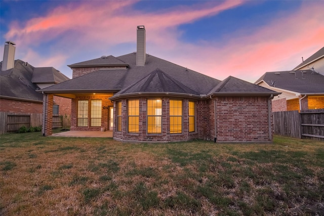 18306 S Austin Shore Dr, Cypress, TX 77433 - rear view of house with brick siding, a patio area, a chimney, and roof with shingles