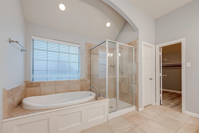 18306 S Austin Shore Dr, Cypress, TX 77433 - full bathroom featuring a shower stall, tile patterned floors, a bath, a spacious closet, and vaulted ceiling
