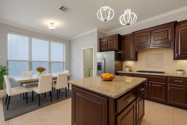 18306 S Austin Shore Dr, Cypress, TX 77433 - kitchen with appliances with stainless steel finishes, light tile patterned floors, crown molding, a center island, and pendant lighting