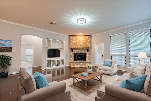 18306 S Austin Shore Dr, Cypress, TX 77433 - living room featuring crown molding, arched walkways, and a stone fireplace