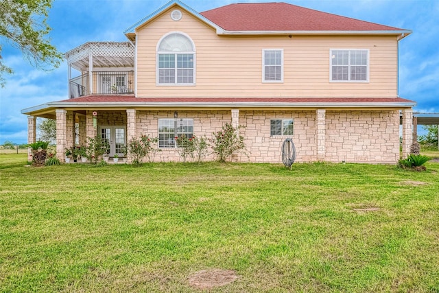 1241 Terrazas Ln, Sealy, TX 77474 - view of front facade featuring a balcony, a front yard, and french doors