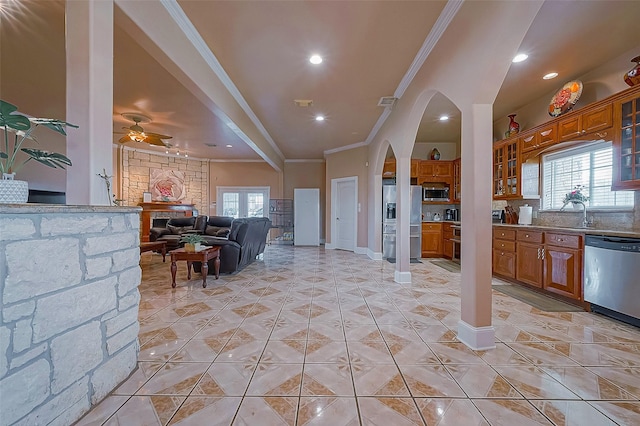 1241 Terrazas Ln, Sealy, TX 77474 - living area featuring ornamental molding, healthy amount of natural light, a ceiling fan, recessed lighting, and arched walkways
