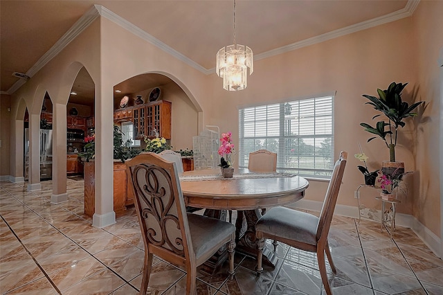 1241 Terrazas Ln, Sealy, TX 77474 - dining room with ornamental molding, arched walkways, a chandelier, and baseboards