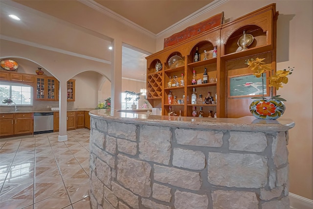 1241 Terrazas Ln, Sealy, TX 77474 - indoor bar with stainless steel dishwasher, ornamental molding, arched walkways, and tasteful backsplash