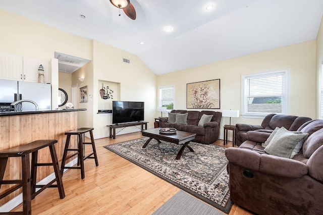 171 County Road 299, Sargent, TX 77414 - living room with light wood-style flooring, a ceiling fan, baseboards, and high vaulted ceiling