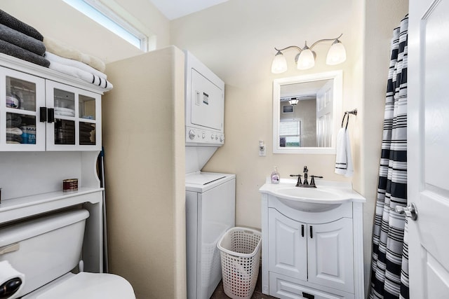 171 County Road 299, Sargent, TX 77414 - bathroom featuring estacked washer and dryer, toilet, and vanity