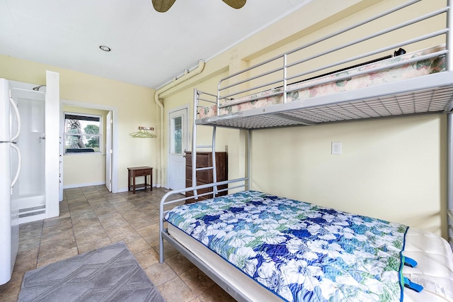 171 County Road 299, Sargent, TX 77414 - bedroom featuring baseboards and freestanding refrigerator