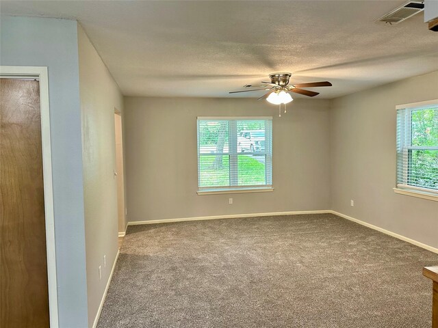 202 Spring Creek Loop, Livingston, TX 77351 - empty room with a ceiling fan, carpet flooring, baseboards, and a textured ceiling
