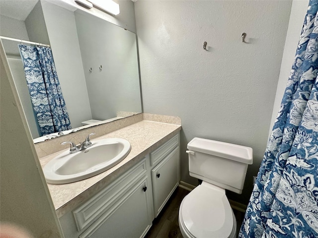 202 Spring Creek Loop, Livingston, TX 77351 - full bathroom with toilet, vanity, and wood finished floors