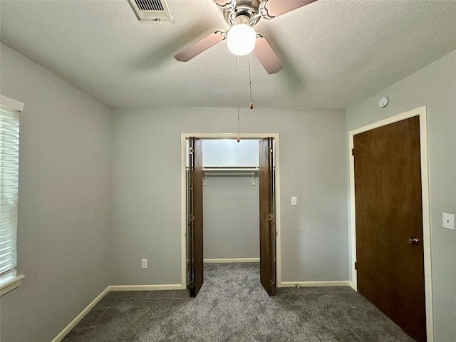 202 Spring Creek Loop, Livingston, TX 77351 - unfurnished bedroom with carpet floors, baseboards, a closet, ceiling fan, and a textured ceiling