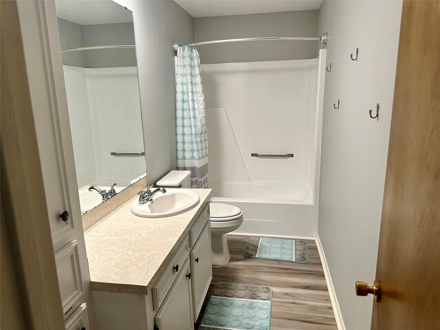 202 Spring Creek Loop, Livingston, TX 77351 - bathroom with wood finished floors, vanity, baseboards, toilet, and shower / bathtub combination with curtain