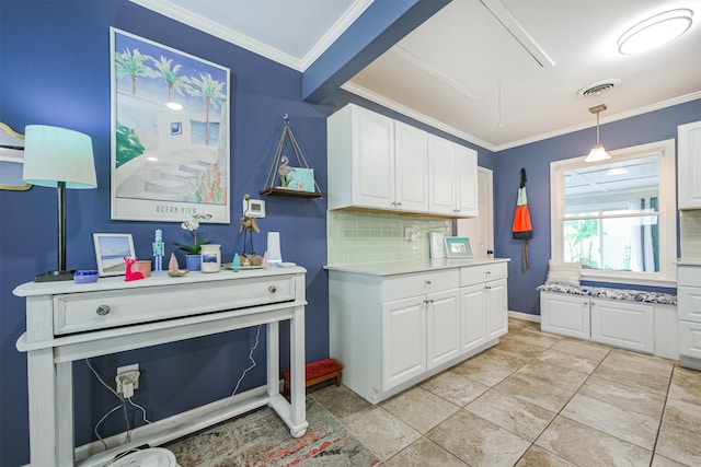 1902 Bayou Shore Dr, Galveston, TX 77551 - kitchen featuring ornamental molding, light countertops, white cabinetry, decorative backsplash, and hanging light fixtures