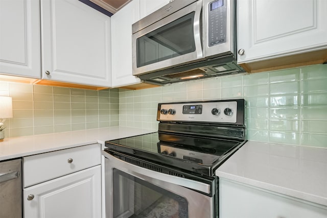1902 Bayou Shore Dr, Galveston, TX 77551 - kitchen with appliances with stainless steel finishes, white cabinetry, tasteful backsplash, and light countertops