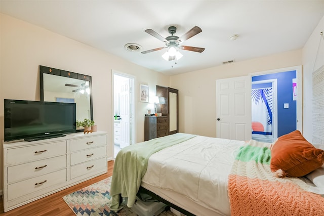 1902 Bayou Shore Dr, Galveston, TX 77551 - bedroom with light wood-type flooring, ceiling fan, and ensuite bathroom