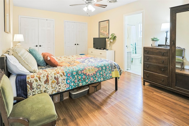 1902 Bayou Shore Dr, Galveston, TX 77551 - bedroom with multiple closets, wood finished floors, ensuite bathroom, and a ceiling fan