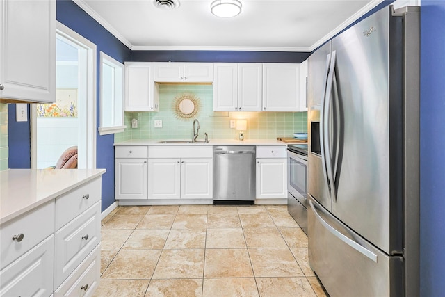 1902 Bayou Shore Dr, Galveston, TX 77551 - kitchen featuring stainless steel appliances, light countertops, tasteful backsplash, white cabinets, and ornamental molding
