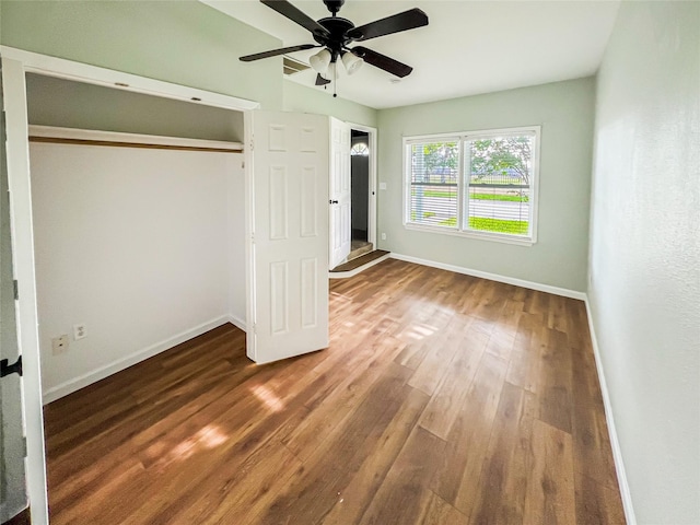 1902 Bayou Shore Dr, Galveston, TX 77551 - unfurnished bedroom with wood finished floors, a ceiling fan, and a closet