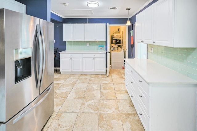 1902 Bayou Shore Dr, Galveston, TX 77551 - kitchen featuring stainless steel fridge with ice dispenser, backsplash, light countertops, crown molding, and white cabinetry