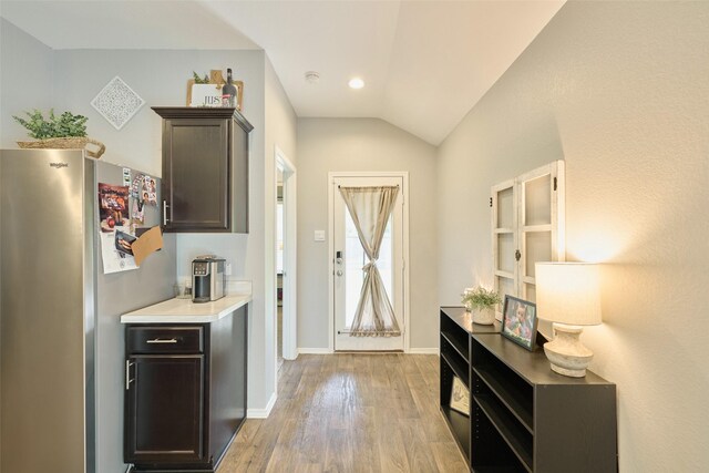 16953 Rich Pines Dr, Conroe, TX 77302 - doorway to outside with light wood-type flooring, vaulted ceiling, and baseboards