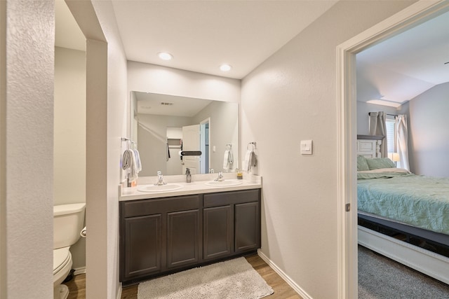 16953 Rich Pines Dr, Conroe, TX 77302 - ensuite bathroom featuring toilet, double vanity, wood finished floors, and baseboards