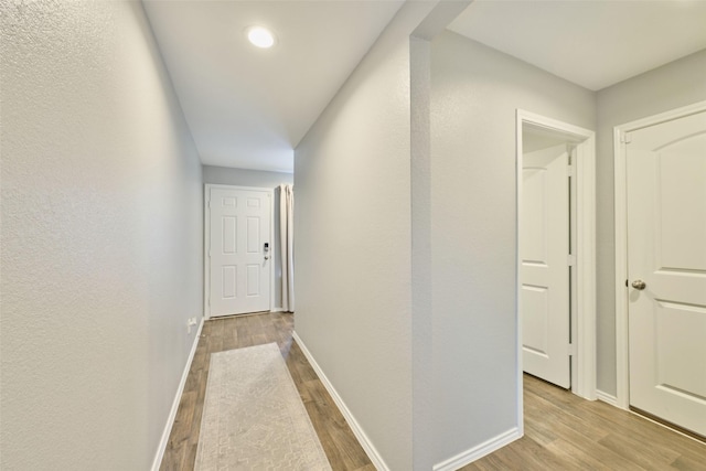 16953 Rich Pines Dr, Conroe, TX 77302 - hallway with wood finished floors, baseboards, and recessed lighting