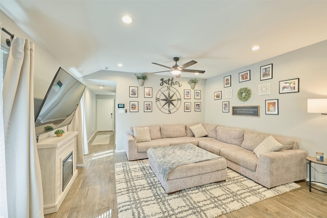 16953 Rich Pines Dr, Conroe, TX 77302 - living area with a ceiling fan, light wood-style floors, recessed lighting, a glass covered fireplace, and baseboards