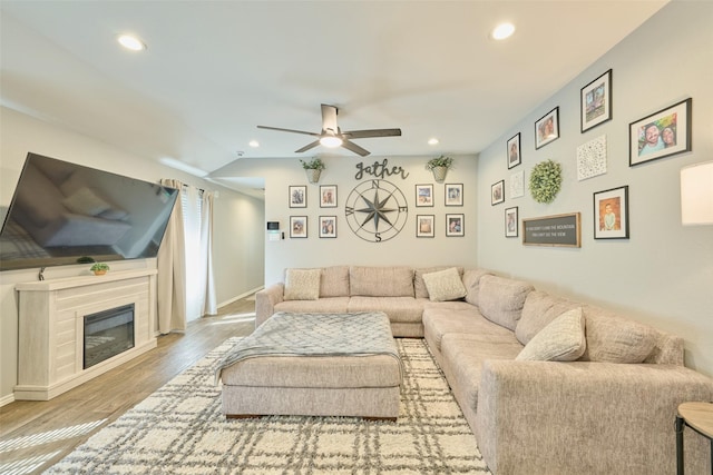 16953 Rich Pines Dr, Conroe, TX 77302 - living room with ceiling fan, wood finished floors, recessed lighting, baseboards, and a glass covered fireplace