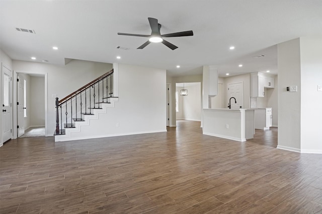 1214 Sabine Brook Way, Houston, TX 77073 - unfurnished living room featuring ceiling fan, wood finished floors, baseboards, a sink, and recessed lighting