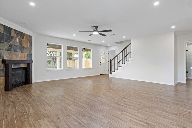 1214 Sabine Brook Way, Houston, TX 77073 - unfurnished living room featuring a ceiling fan, recessed lighting, wood finished floors, baseboards, and stairway