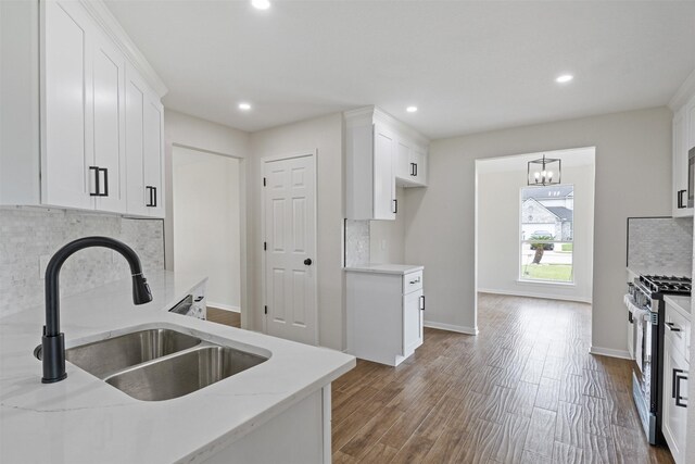 1214 Sabine Brook Way, Houston, TX 77073 - kitchen featuring stainless steel range with gas cooktop, a sink, decorative backsplash, light stone countertops, and white cabinets