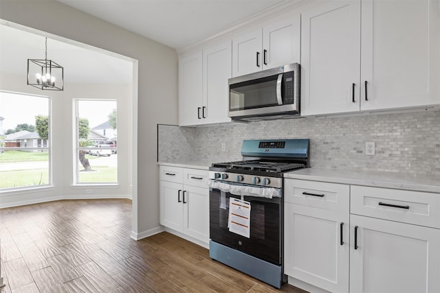 1214 Sabine Brook Way, Houston, TX 77073 - kitchen with stainless steel appliances, light countertops, a chandelier, and backsplash