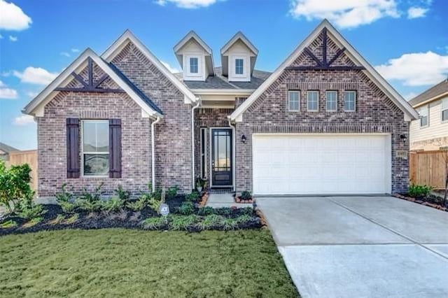 32307 Elmwood Mnr, Waller, TX 77484 - view of front of home featuring brick siding, driveway, and an attached garage