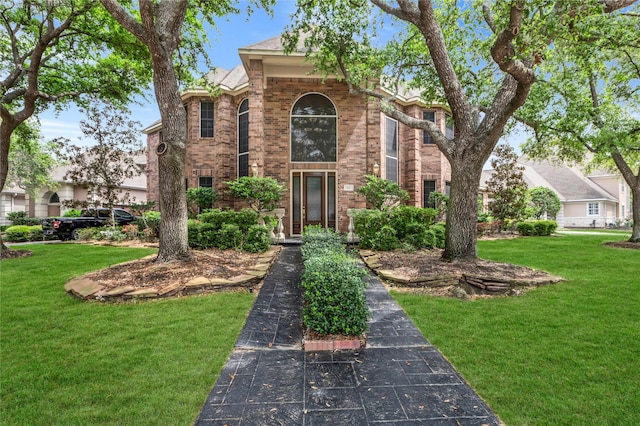 24 Stonegate Park Ct, Spring, TX 77379 - traditional-style house featuring brick siding and a front yard