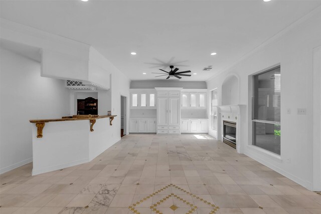 24 Stonegate Park Ct, Spring, TX 77379 - unfurnished living room featuring a tile fireplace, ceiling fan, recessed lighting, and ornamental molding