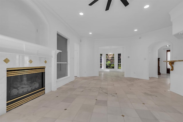 24 Stonegate Park Ct, Spring, TX 77379 - unfurnished living room featuring ceiling fan, arched walkways, recessed lighting, and a tile fireplace