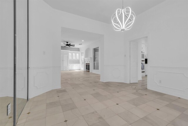 24 Stonegate Park Ct, Spring, TX 77379 - unfurnished dining area featuring a decorative wall, a chandelier, and a wainscoted wall