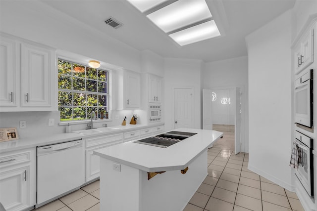 24 Stonegate Park Ct, Spring, TX 77379 - kitchen featuring white appliances, a sink, light tile patterned floors, and a kitchen island