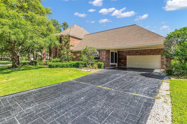24 Stonegate Park Ct, Spring, TX 77379 - view of front of home with a garage, a front lawn, concrete driveway, and a shingled roof