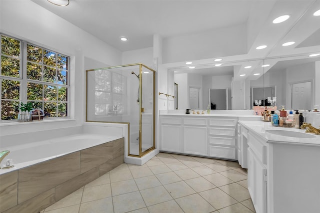 24 Stonegate Park Ct, Spring, TX 77379 - bathroom featuring healthy amount of natural light, a shower stall, a bath, tile patterned floors, and recessed lighting