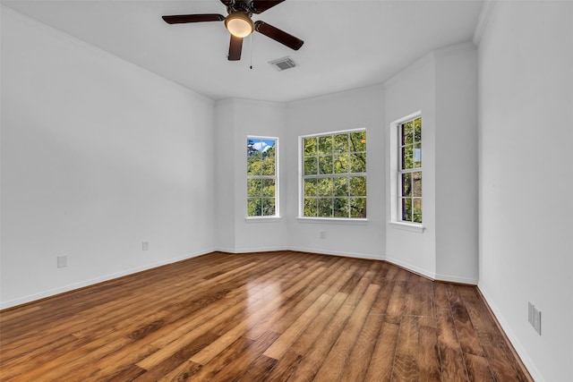 24 Stonegate Park Ct, Spring, TX 77379 - unfurnished room with healthy amount of natural light, wood finished floors, a ceiling fan, baseboards, and crown molding