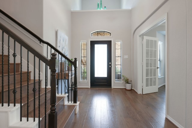 6706 Miller Shadow Ln, Sugar Land, TX 77479 - foyer entrance featuring wood finished floors, stairs, baseboards, and a towering ceiling