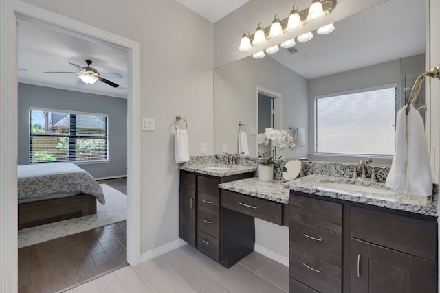 6706 Miller Shadow Ln, Sugar Land, TX 77479 - ensuite bathroom with baseboards, double vanity, a ceiling fan, and wood finished floors