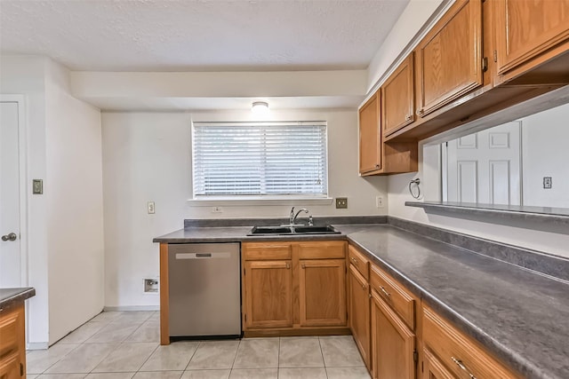 3915 Rosemont Dr, La Porte, TX 77571 - kitchen with stainless steel dishwasher, a sink, dark countertops, brown cabinetry, and light tile patterned floors